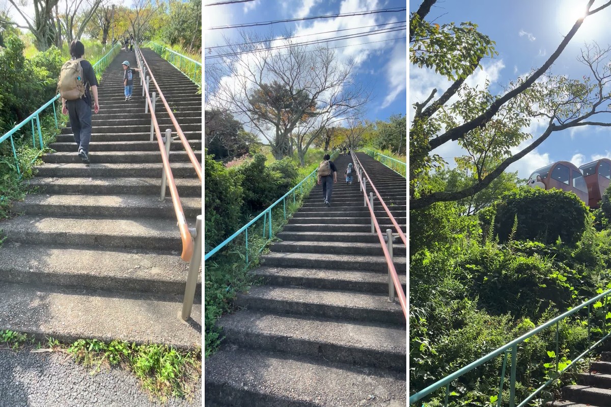 駐車場から遊園地へ上がる急な階段。木々の上をりすの乗り物が走る