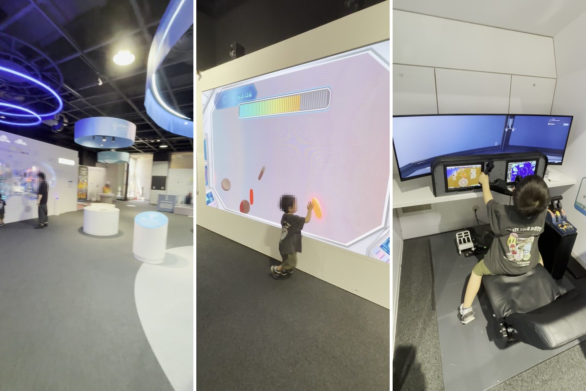 バンドー神戸青少年科学館の展示フロア、大画面にタッチするゲーム、飛行機のコックピットに座って操縦する3歳の子ども