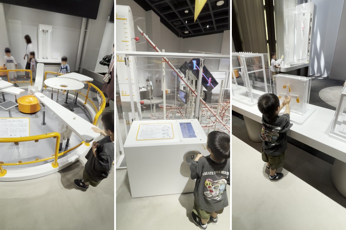 バンドー神戸青少年科学館の物理・化学の展示室。円盤状の実験装置スパークポッド、ハンドルを回して動かす展示、しくみを手で確かめる展示で遊ぶ3歳の子ども