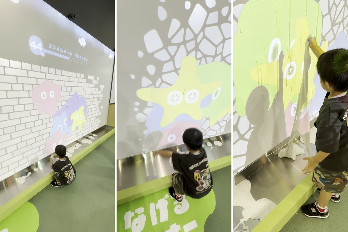 なげるコーナー。白い壁にスライムを投げる子どもの後ろ姿と、投げた場所から映像がはじけて色が広がる様子